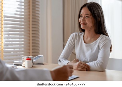 A young girl engaging in a conversation with a social worker or psychologist, focusing on mental health, depression, and counseling during a therapy session. - Powered by Shutterstock