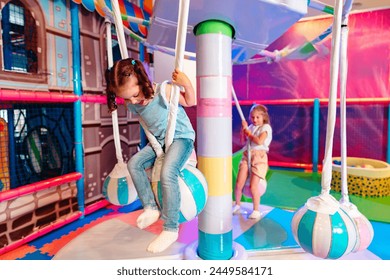 Young Girl Enjoying Playtime at an Indoor Playground on a Bright Day - Powered by Shutterstock