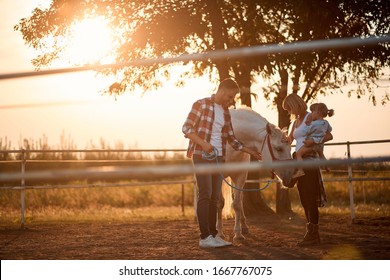 Young Girl And Family With A Horse In The Farm. Petting Horses In Countryside. 