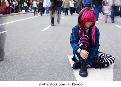 Young girl feeling solitude among the blurred crowd.