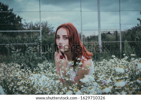 Similar – Young redhead woman surrounded by plants