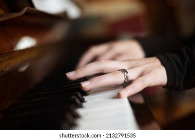 The Young Girl Is Focused On Playing The Piano, Preparing For A Performance On Stage At  Music School, Selective Focus, Focus On The Girl's Fingers. The Concept Of Music Education, Playing The Piano