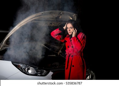 Young Girl Frustrated Waiting For Help Beside Broken Car With Open Hood And Smoke At Night