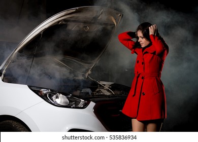 Young Girl Frustrated Waiting For Help Beside Broken Car With Open Hood And Smoke At Night