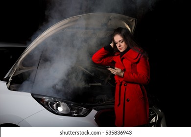 Young Girl Frustrated Waiting For Help Beside Broken Car With Open Hood And Smoke At Night