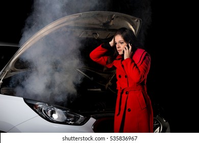 Young Girl Frustrated Waiting For Help Beside Broken Car With Open Hood And Smoke At Night