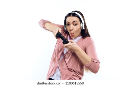 Young Girl Gamer In Headphones With Joystick Playing Computer Game. Isolated On White Background. Studio Portrait.