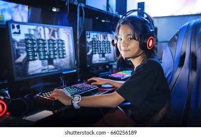 Young Girl Gamer Playing Game Computer Online In Internet Cafe