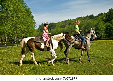 A young girl getting a horseback riding lesson. - Powered by Shutterstock