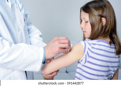 Young Girl Is Getting Vaccination Shot By Doctor Against Flu Infection