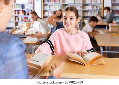 Young Girl Giving Books To Librarian After Reading In Study Hall.