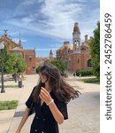young girl with glasses and a black dress in Recinte Modernista de Sant Pau on a sunny day