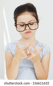 Young Girl In Glasses Counting Fingers