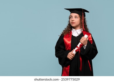 Young girl in graduation gown looking up thoughtfully while holding a diploma. Graduate celebrating graduation. Education concept. Successful primary school. - Powered by Shutterstock