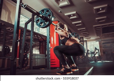 Young Girl In The Gym Doing Squat