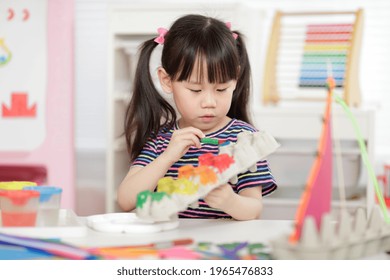 young girl hand making boat craft using egg cartons  for homesch - Powered by Shutterstock