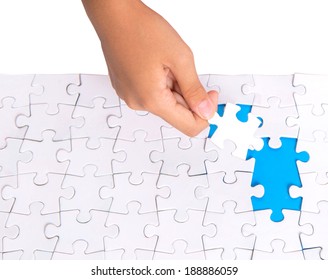 Young Girl Hand Putting Jigsaw Puzzle Pieces Together