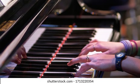 Young Girl Hands Playing Grand Piano In Concert Or Class, Wearing Colorful Bracelets, Rings And Wrist Watch Made For Kids Or Teenagers. Traditional Unbranded, Unrecognizable Piano And Generic Watch