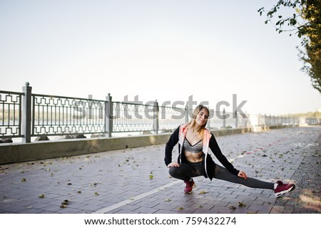 Similar – Young woman stretching arms before training outdoors