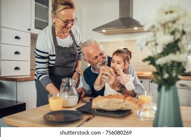 Young girl having breakfast with her grandparents