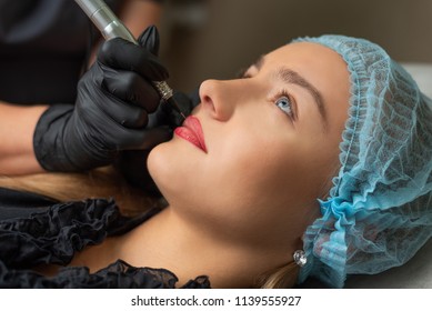 A Young Girl Having Red Lips Permanent Makeup, Micropigmentation.