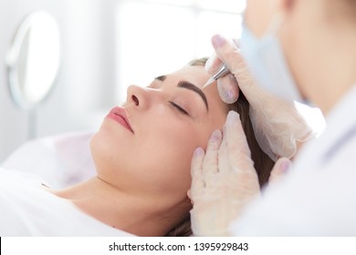 A Young Girl Having Red Lips Permanent Makeup, Micropigmentation