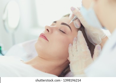 A Young Girl Having Red Lips Permanent Makeup, Micropigmentation