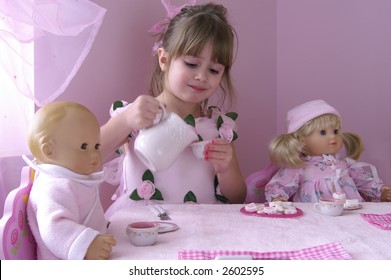 A Young Girl Having A Tea Party With Her Baby Dolls