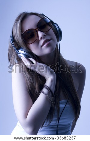 Similar – Young blonde woman listening to music with her headphones