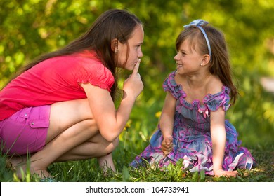 Young Girl With Her Finger Over Her Mouth Shows For Mischievous Child - Shh. Secret.