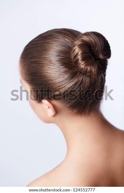 Young girl with her hair in a\
bun