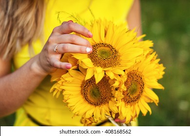 Young Girl Holding A Bouquet Of Sunflowers