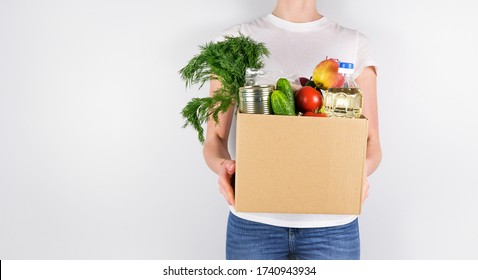 Young girl holding box with donations on grey background. Place for a text. - Shutterstock ID 1740943934