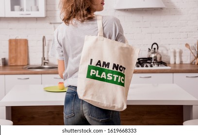 Young girl holding a cloth bag. At the kitchen. I am not plastic. Campaign to reduce the use of plastic bags. Zero waste - Shutterstock ID 1619668333