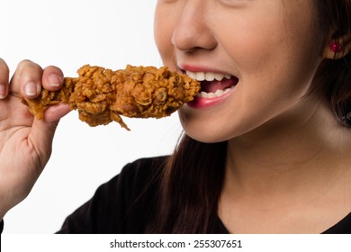 Young Girl Holding, Eating Fried Chicken