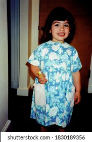 Young Girl Holding Her First Toothbrush And Smiling.  Vintage Scan Of 1990s Family Photo (1997).