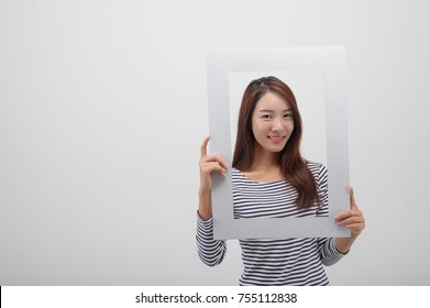 A Young Girl Holding A Picture Frame.