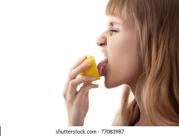 young girl holding a sour lemon isolated