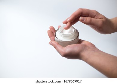 Young Girl Holds A Cream. Face Cream. Body Cream. Cuticle Cream. Copy Space. Beauty Concept 