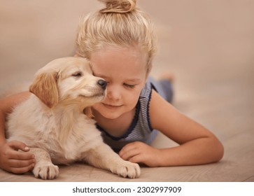 Young girl hug her dog, relax with peace and calm at home with golden retriever puppy and child. Mans best friend, pet care and love with female kid and her domestic animal lying on wood floor