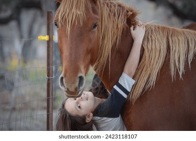 Young Girl Hugging From Red Horse - Powered by Shutterstock