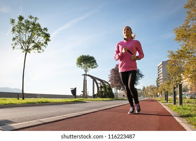 Young Girl Jogging Outdoor Along Trees Path