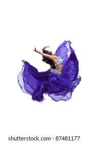 Young girl jump in purple oriental eastern veil