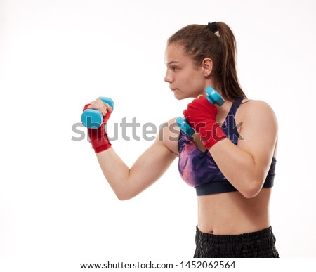 Young girl kickboxing fighter training, isolated on white background