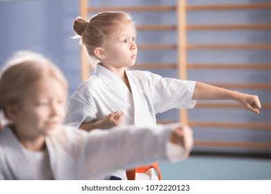 Young Girl In Kimono Exercising During An Extra-curricular Karate Class