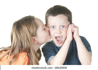 young girl kissing boy on cheek