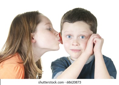 young girl kissing boy on cheek