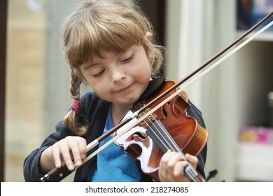 Young Girl Learning To Play Violin