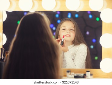 Young Girl With Lipstick Sitting Mear A Mirror.