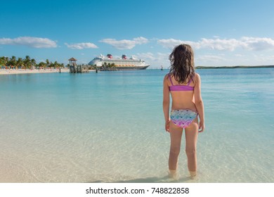 Young girl looking at cruise ship in Caribbean. - Shutterstock ID 748822858